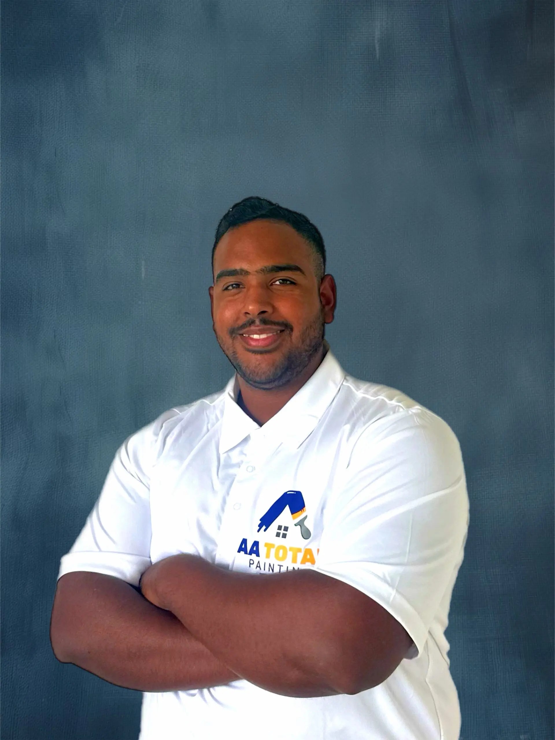 a man crossing his arms while smiling